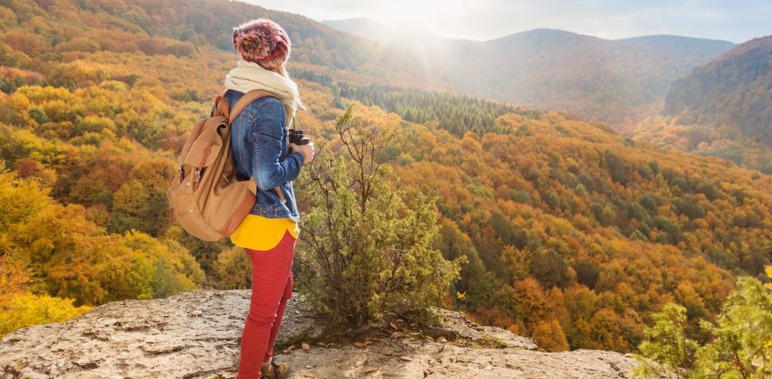 Beautiful young woman on a walk in autumn forest