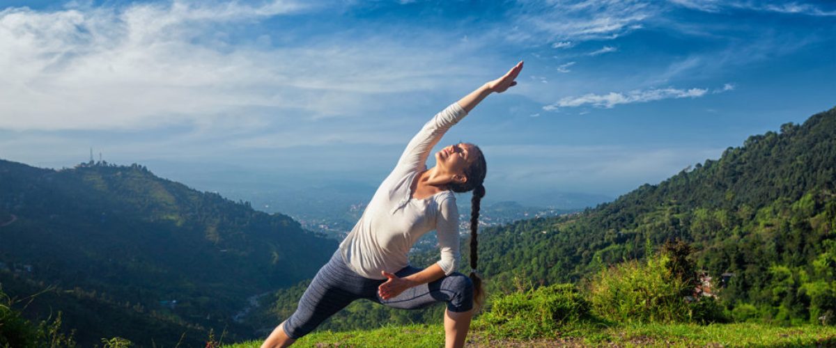 woman-practices-yoga-mountain